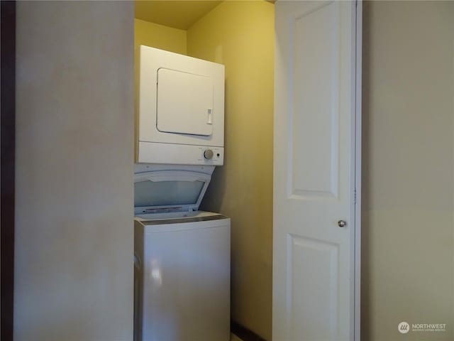 washroom featuring stacked washer and dryer