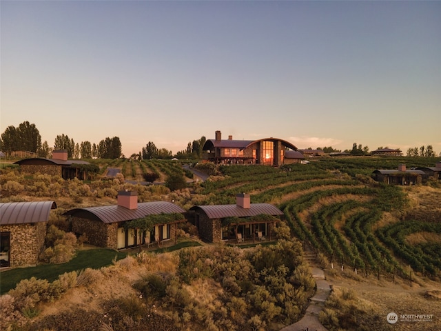 aerial view at dusk featuring a rural view