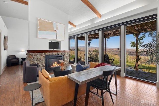 sunroom / solarium with a fireplace and lofted ceiling with beams