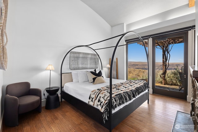 bedroom with access to outside and dark wood-type flooring