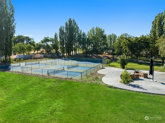 view of sport court with a yard