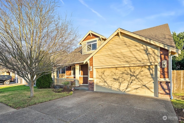 view of front of house featuring a porch, a garage, and a front yard