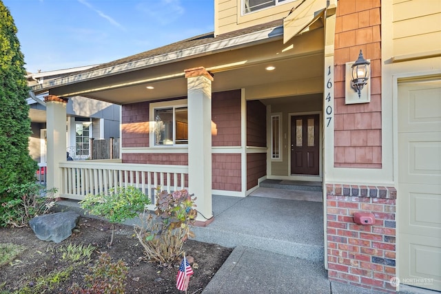 view of exterior entry with covered porch