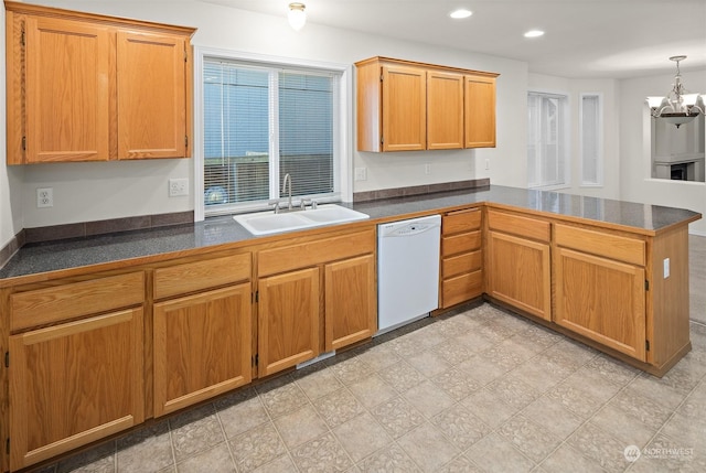 kitchen featuring kitchen peninsula, white dishwasher, sink, pendant lighting, and a notable chandelier