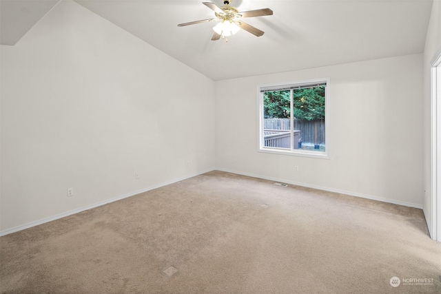 empty room featuring carpet flooring, vaulted ceiling, and ceiling fan