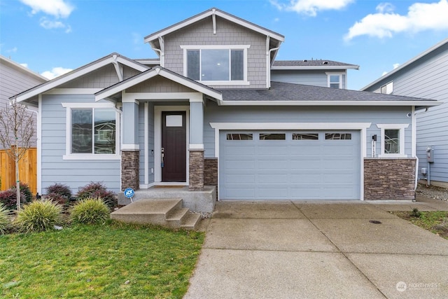 craftsman-style home with a garage and a front lawn