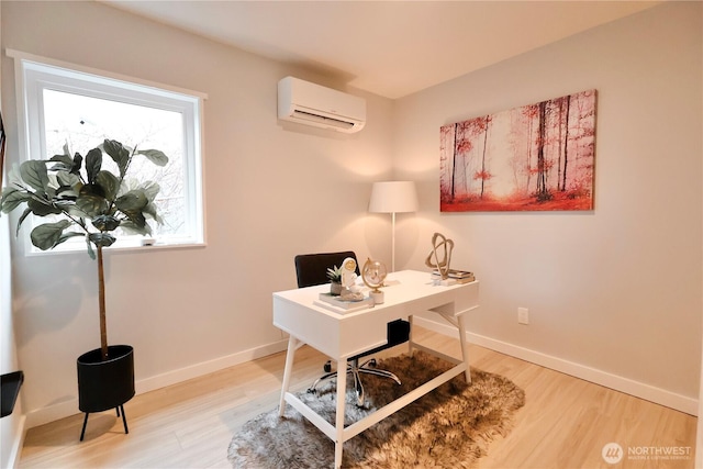 office area featuring light wood-style floors, a wall mounted air conditioner, and baseboards