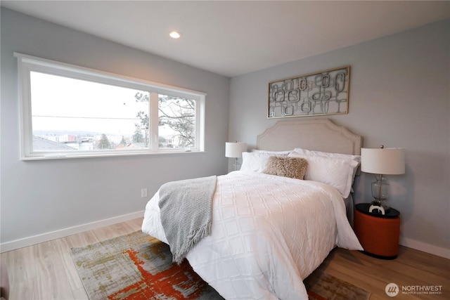 bedroom with recessed lighting, baseboards, and wood finished floors