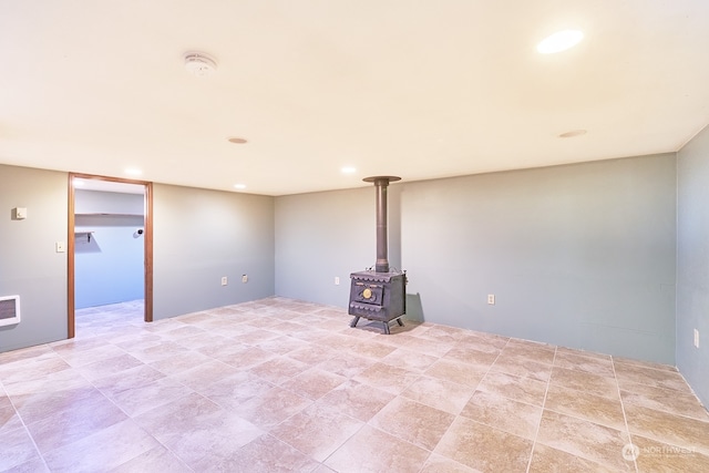 unfurnished living room with a wood stove