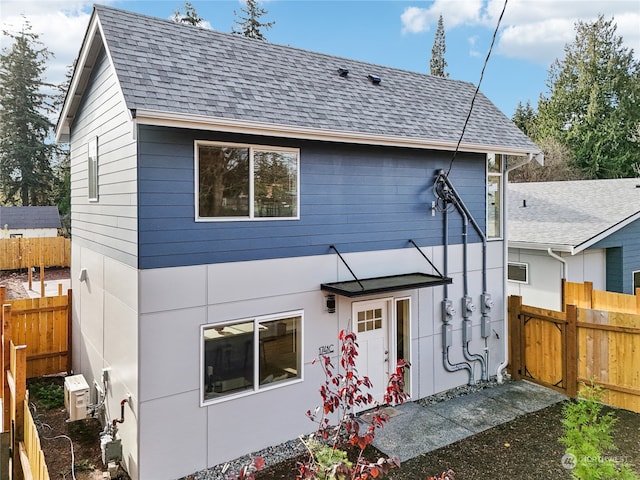 rear view of property featuring ac unit