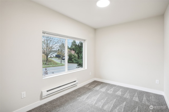 empty room featuring carpet and a baseboard radiator