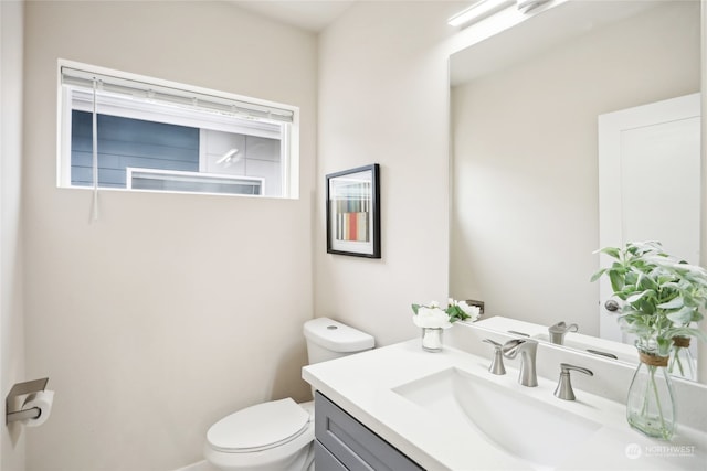 bathroom with vanity and toilet