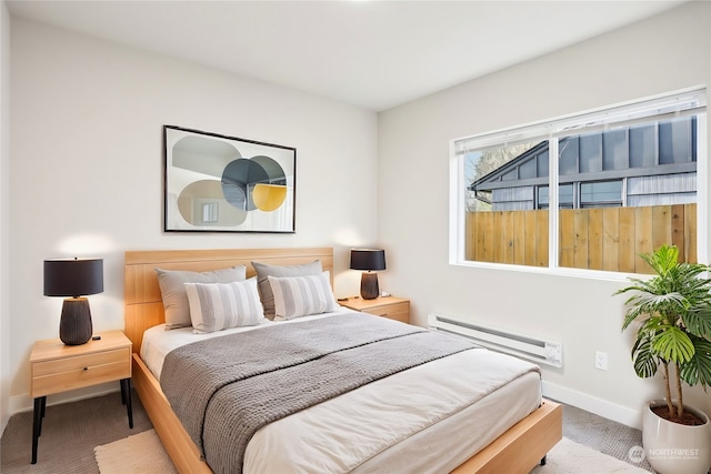 bedroom featuring carpet flooring and a baseboard heating unit