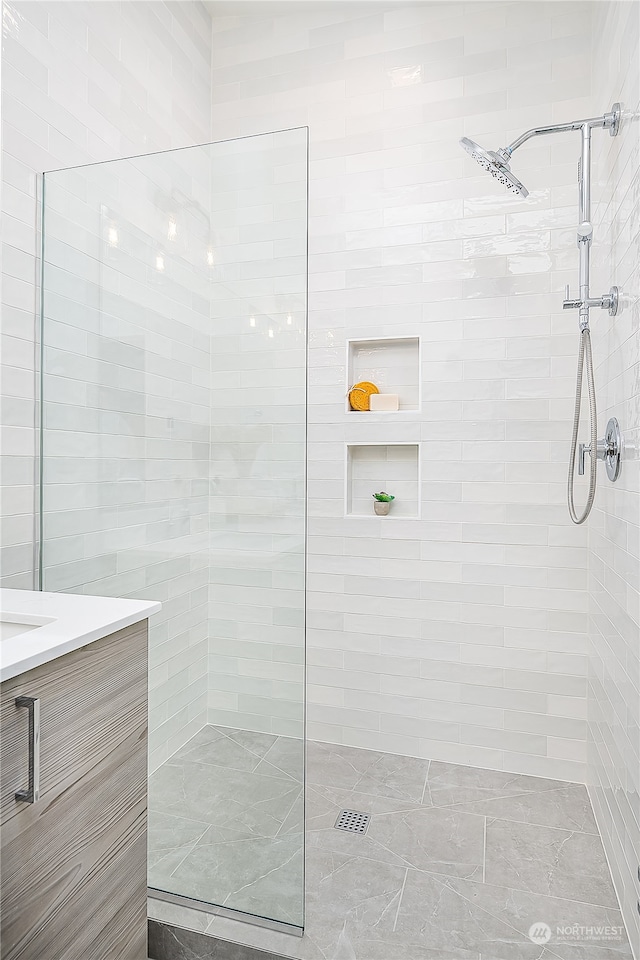 bathroom featuring vanity and a tile shower