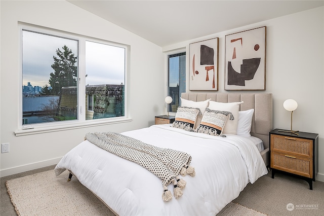 bedroom with carpet flooring and vaulted ceiling