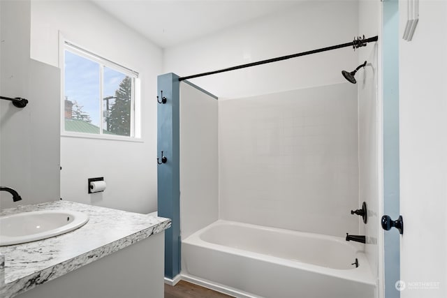 bathroom featuring hardwood / wood-style flooring, vanity, and shower / bath combination