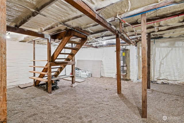 basement featuring carpet flooring and electric water heater