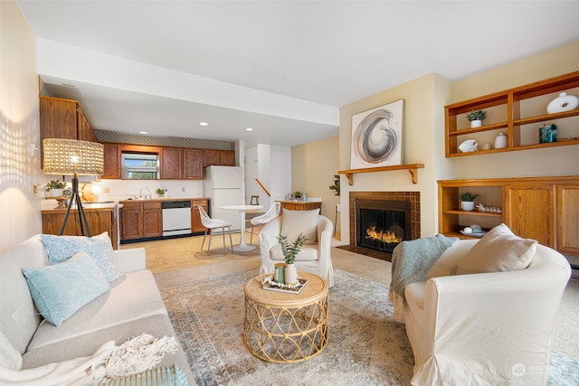 living room with a fireplace and sink