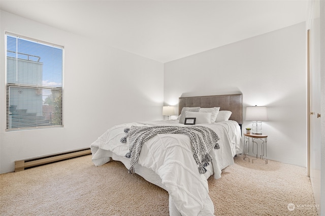 bedroom with carpet and a baseboard radiator