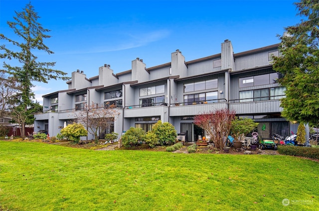 rear view of property with a yard