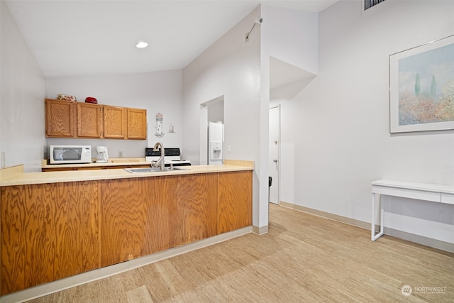 kitchen featuring kitchen peninsula, white appliances, high vaulted ceiling, and sink