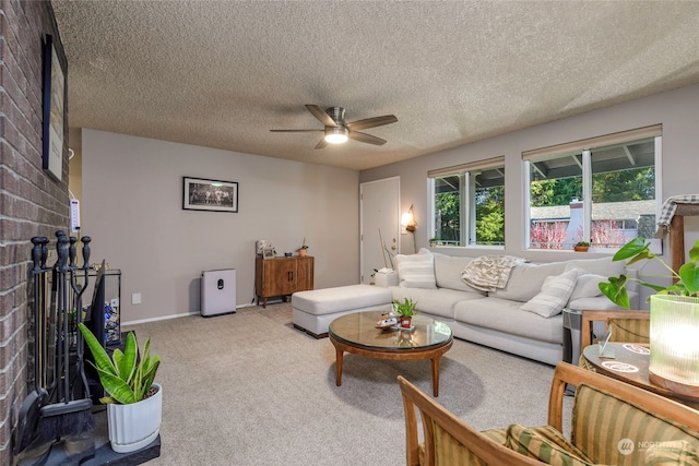 carpeted living room with ceiling fan, a fireplace, and a textured ceiling