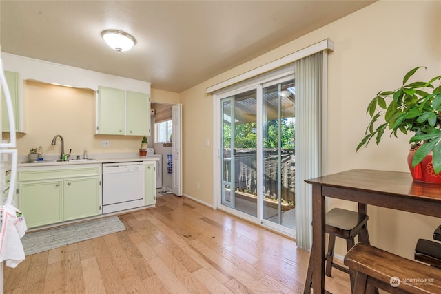 kitchen with green cabinets, dishwasher, light hardwood / wood-style flooring, and sink