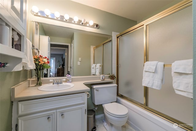 full bathroom featuring tile patterned floors, vanity, toilet, and bath / shower combo with glass door