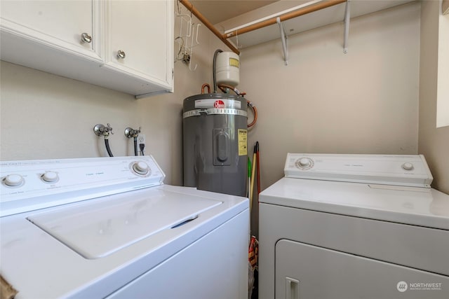 washroom with cabinets, independent washer and dryer, and water heater