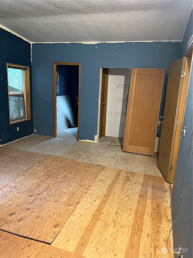 unfurnished room featuring a textured ceiling