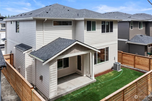 rear view of property featuring a lawn and a patio area