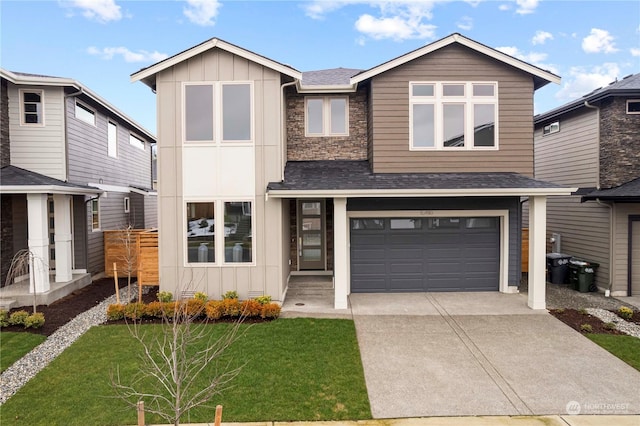 view of front of home with a garage and a front yard