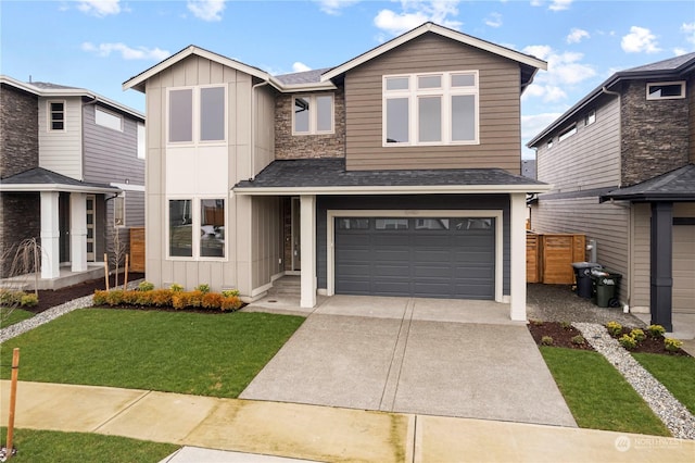 view of front of home with a garage and a front lawn