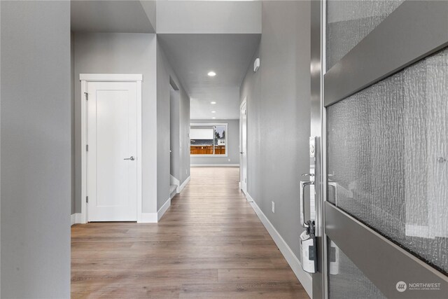 hall with light hardwood / wood-style flooring