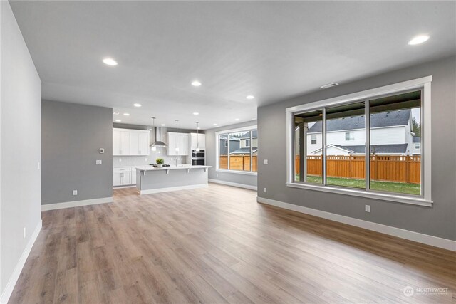 unfurnished living room with light hardwood / wood-style flooring