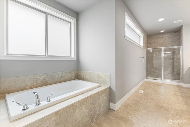 bathroom with independent shower and bath and tile patterned floors