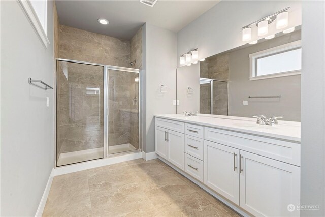 bathroom featuring an enclosed shower and vanity