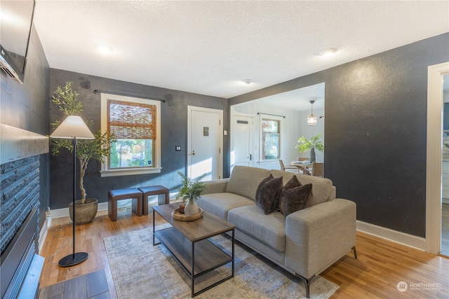 living room featuring hardwood / wood-style floors and a textured ceiling