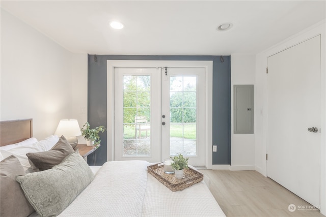 bedroom with french doors, electric panel, light hardwood / wood-style floors, and access to outside