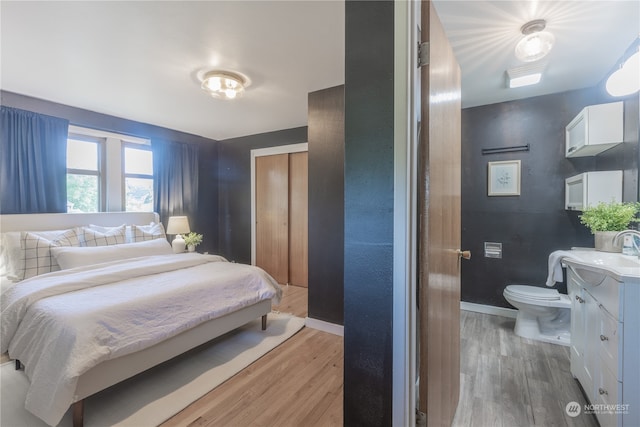 bedroom with light wood-type flooring and sink