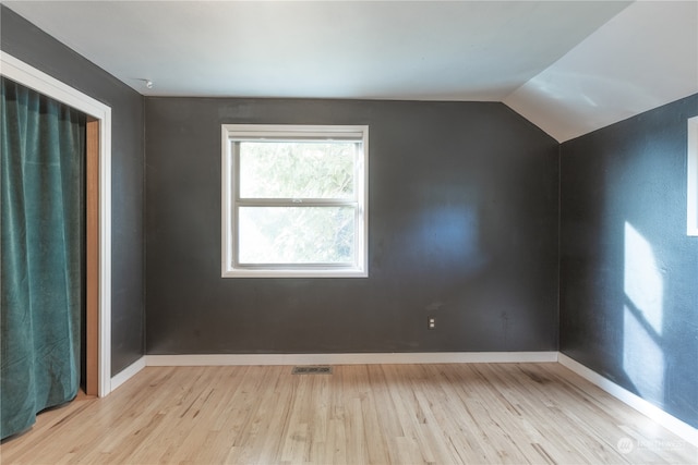 interior space with light wood-type flooring and lofted ceiling