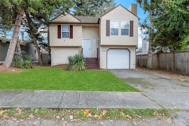 view of front of house featuring a garage and a front yard