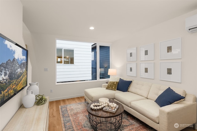 living room featuring wood-type flooring and an AC wall unit