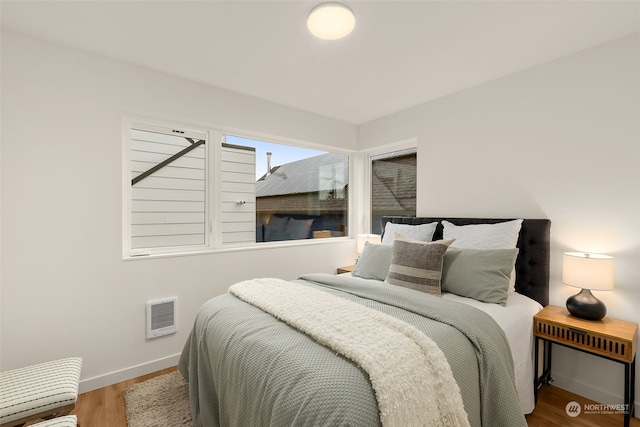 bedroom with hardwood / wood-style floors