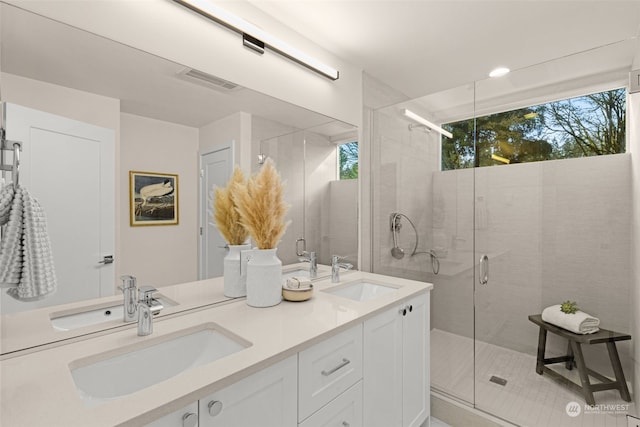 bathroom with tile patterned floors, vanity, and an enclosed shower