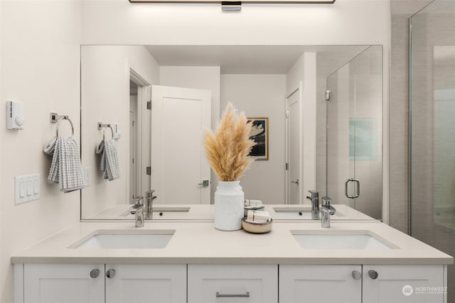 bathroom with vanity and a shower with shower door