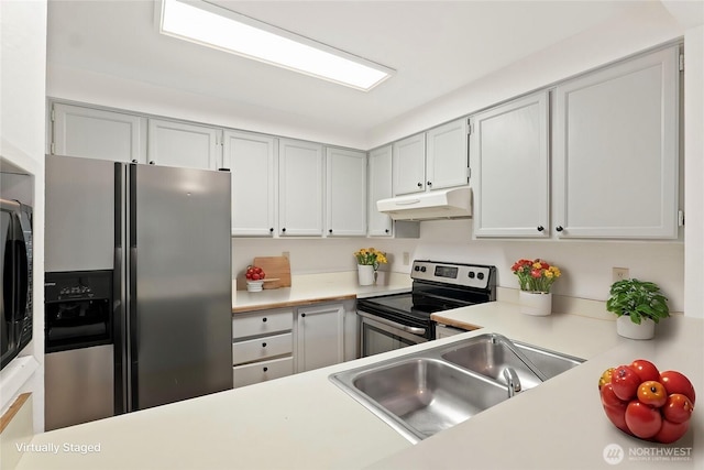 kitchen featuring stainless steel appliances, light countertops, a sink, and under cabinet range hood