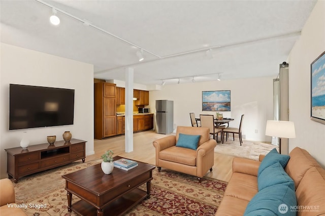 living room featuring light wood-type flooring and track lighting