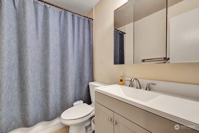 bathroom with tile patterned flooring, vanity, toilet, and walk in shower