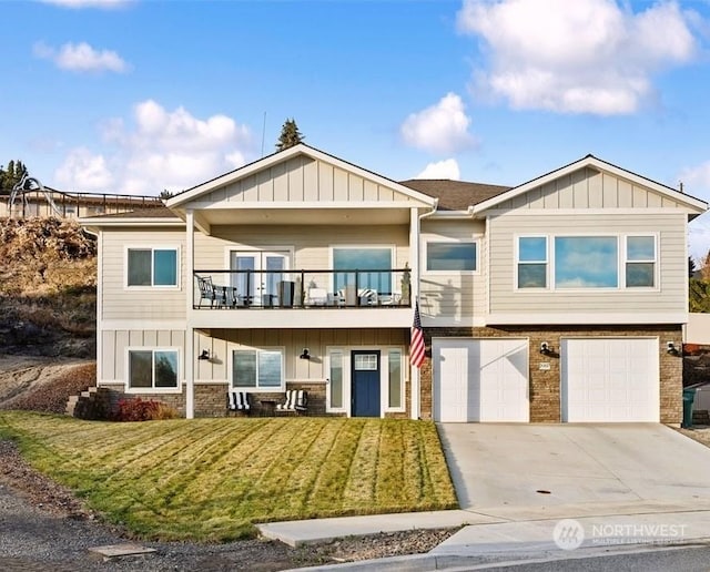 view of front of property with a garage, a balcony, and a front lawn